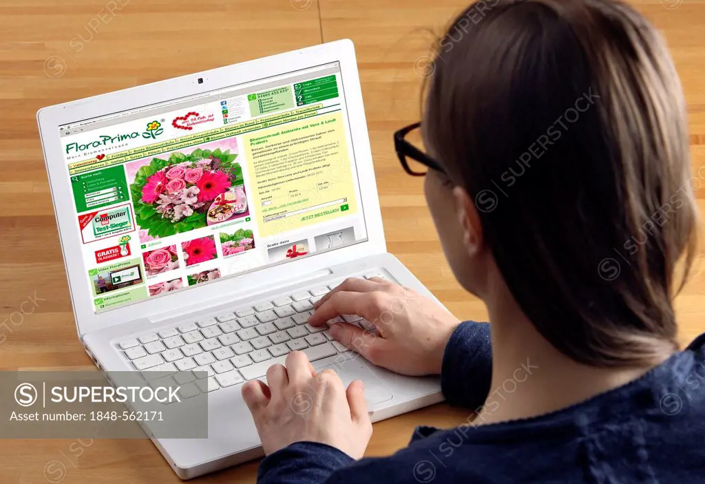 Woman surfing the internet with a laptop, online shop for flowers