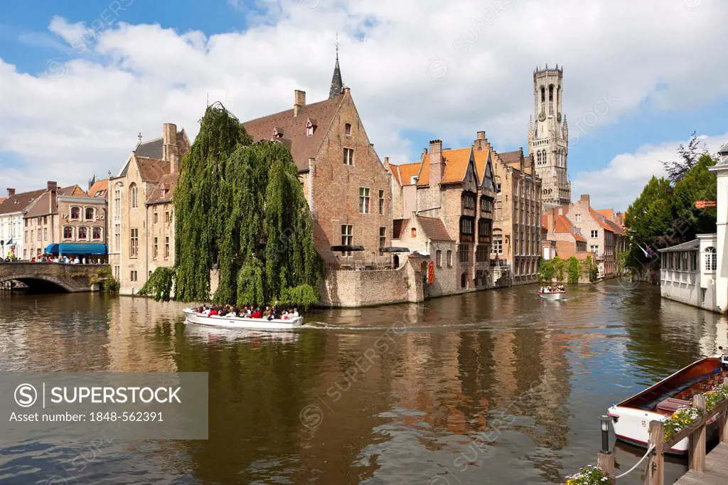 Excursion boat with tourists at the Historical Centre with guild houses on Rozenhoedkaai, Quay of the Rosary, historic city centre of Bruges, UNESCO W...