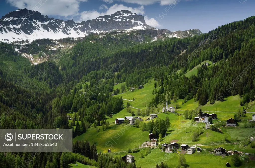 Landscape with a mountain village below the mountain peaks of the Dolomites, Italy, Europe