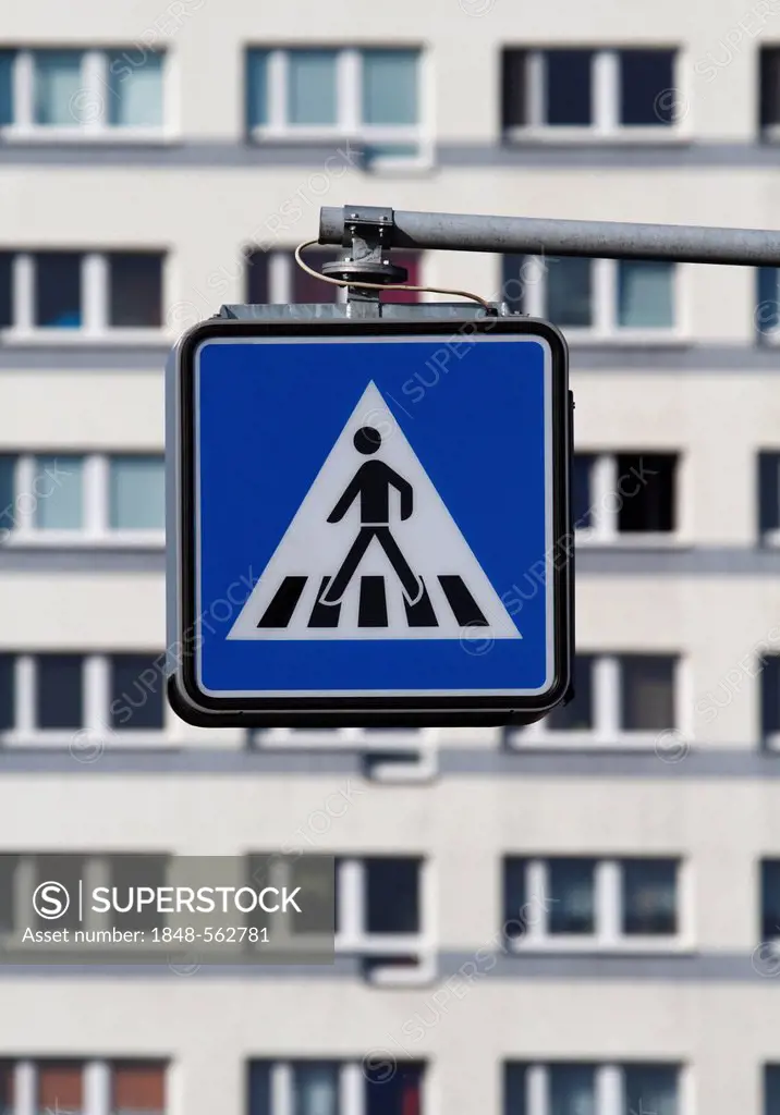 Pedestrian crossing sign in front of apartment buildings