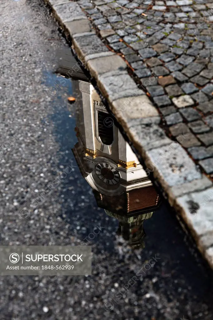 Steinertor gate reflected in a puddle of water in Krems, Wachau, Lower Austria, Austria