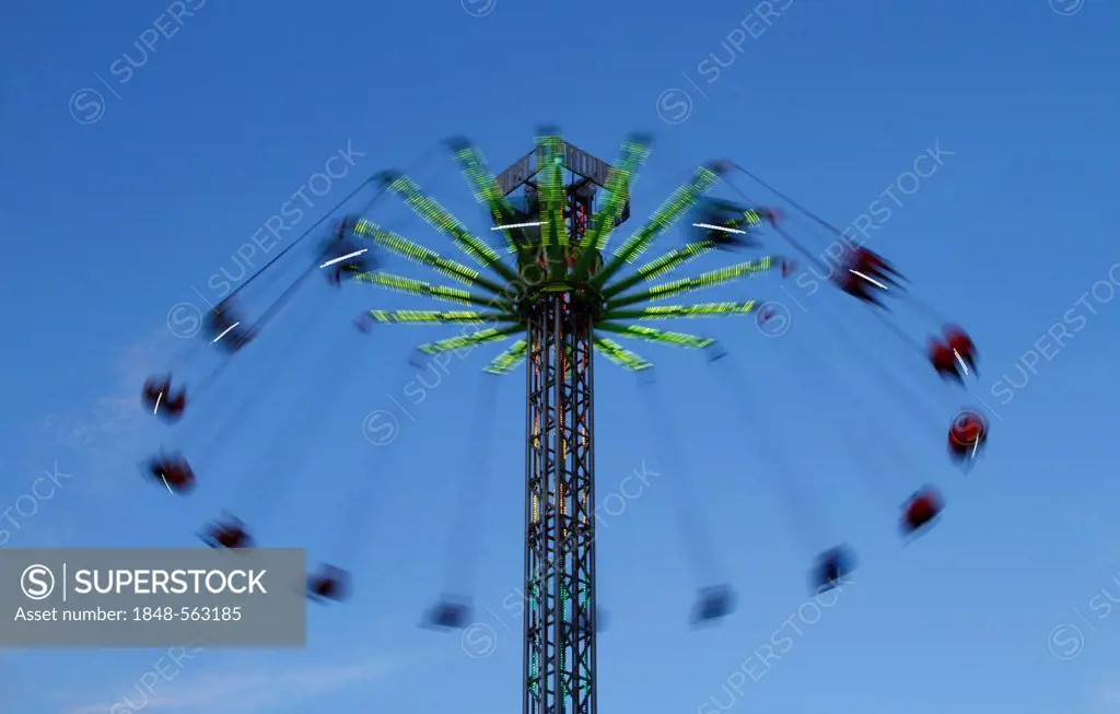 Carousel against a blue sky, blurred