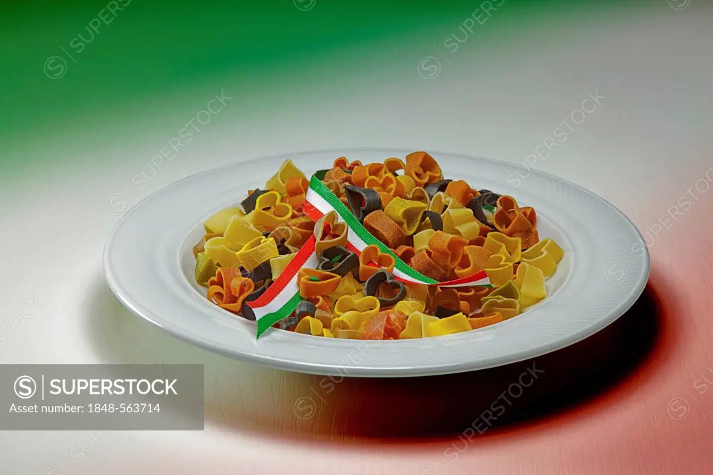 Colourful heart-shaped pasta with a ribbon in the Italian national colours