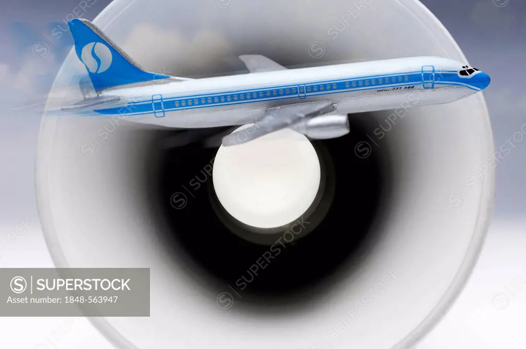 Miniature airplane in front of a megaphone, symbolic image for aircraft noise