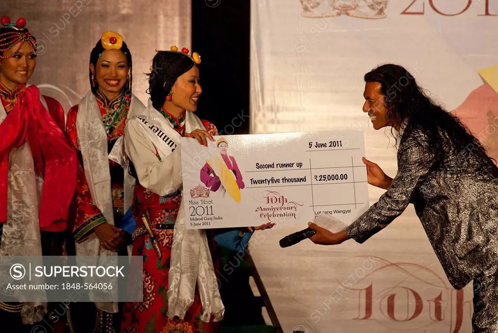Dolma Tsering, participant of the Miss Tibet in Exile 2011 beauty contest in Dharamsala being handed over a check by Lobsang Wangyal for winning the s...