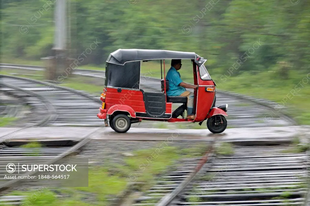 Three-wheeler in heavy rain, railway crossing in Kalawewa, Sri Lanka, Ceylon, South Asia, Asia, PublicGround