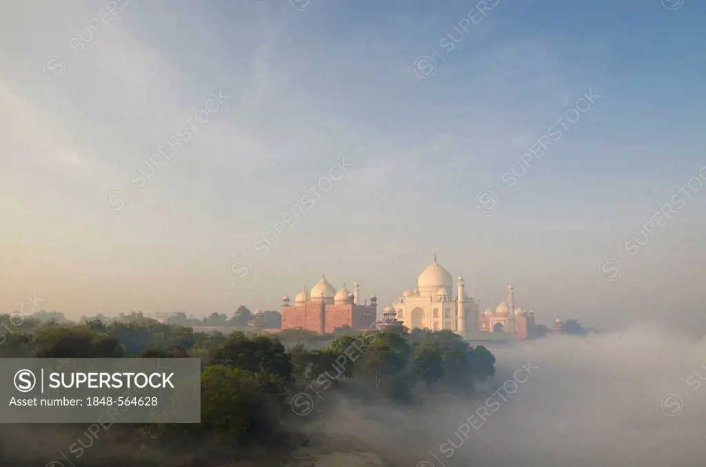 Taj Mahal, UNESCO World Heritage Site, arising out of the morning fog over river Yamuna, Agra, Uttar Pradesh, India, Asia