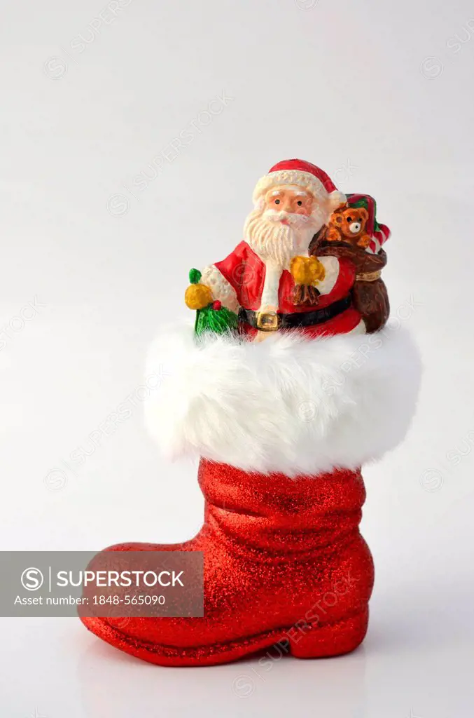 Santa Claus in a Christmas boot, with a bag with toys and gifts, wooden Christmas tree ornament, Christmas decoration