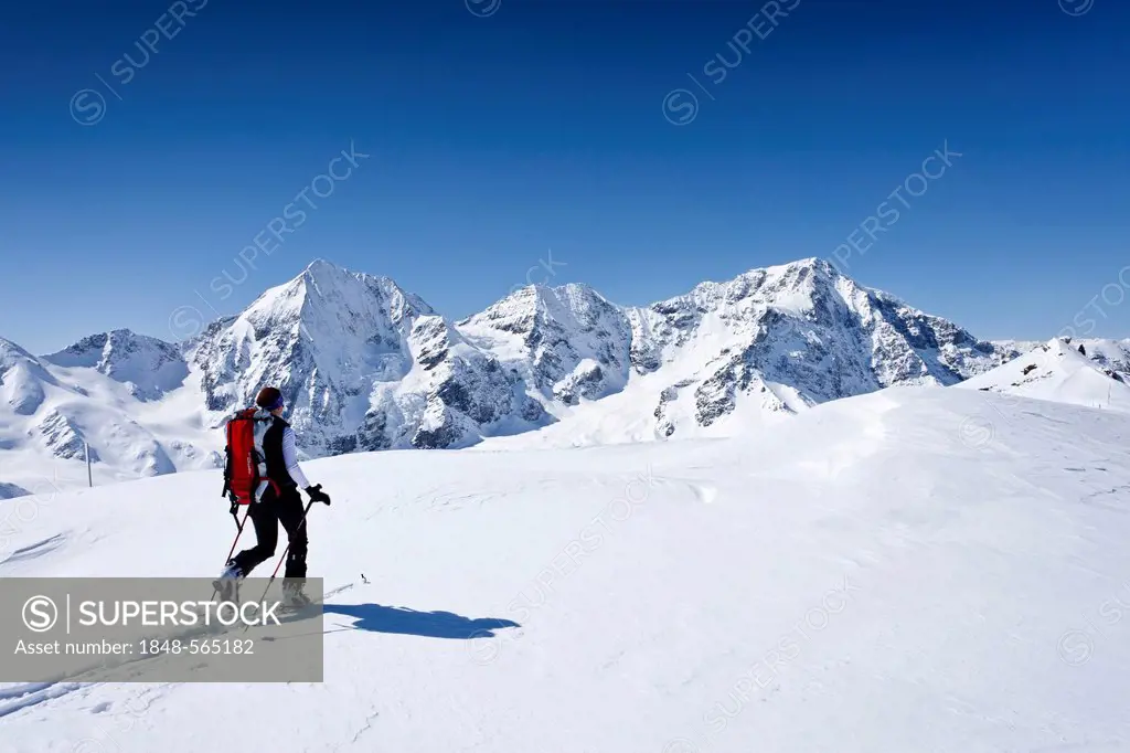 Ski hiker during the ascent to Mt Schoentaufspitze, Sulden in winter, Mt Koenigsspitze, Mt Ortler and Mt Zebru at back, South Tyrol, Italy, Europe