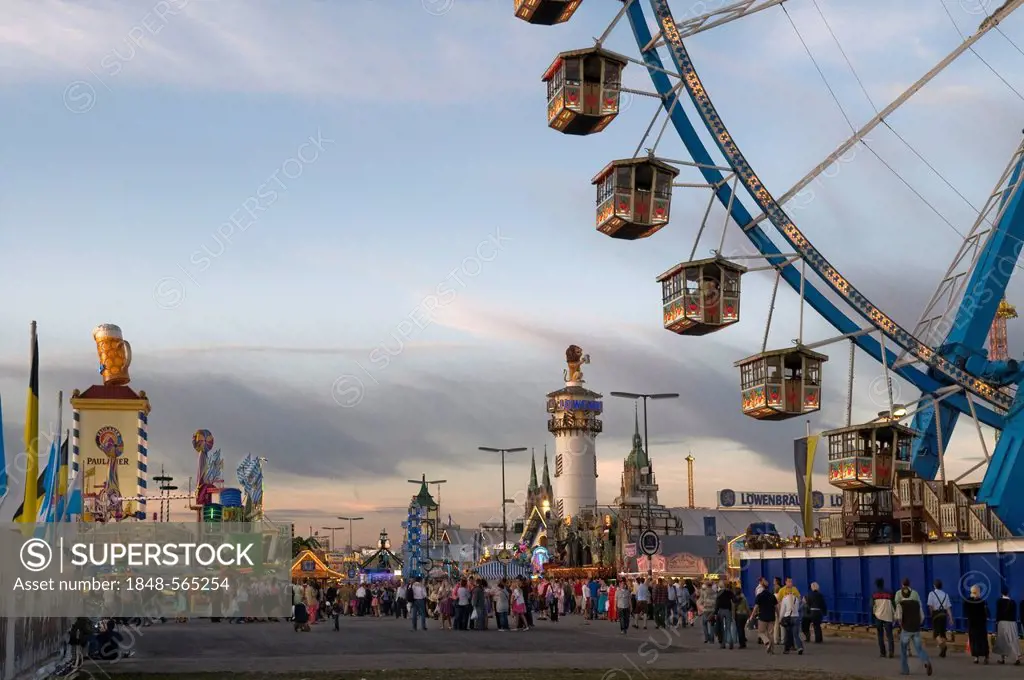 Ferris wheel, Oktoberfest, Wiesn, dawn, Wirtsbudenstrasse and Paulskirche or St. Paul's church in the back, Munich, Upper Bavaria, Germany, Europe