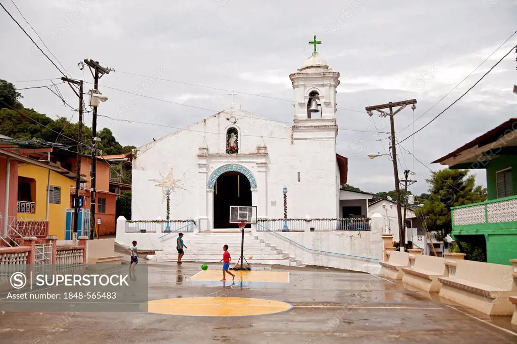 Children playing in front of a church on the island of Isla Taboga, Panama, Central America