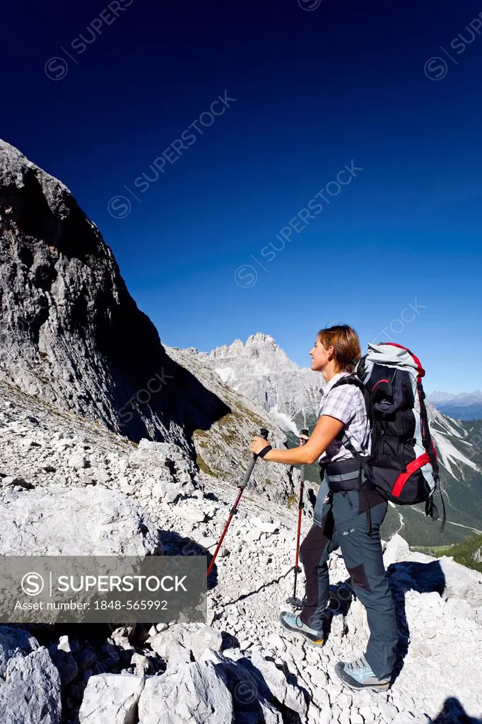 Hiker heading to the Alpinisteig or Strada degli Alpini via ferrata, through the Fischleintal valley or Val Fiscalina above the Talschlusshuette or Ri...