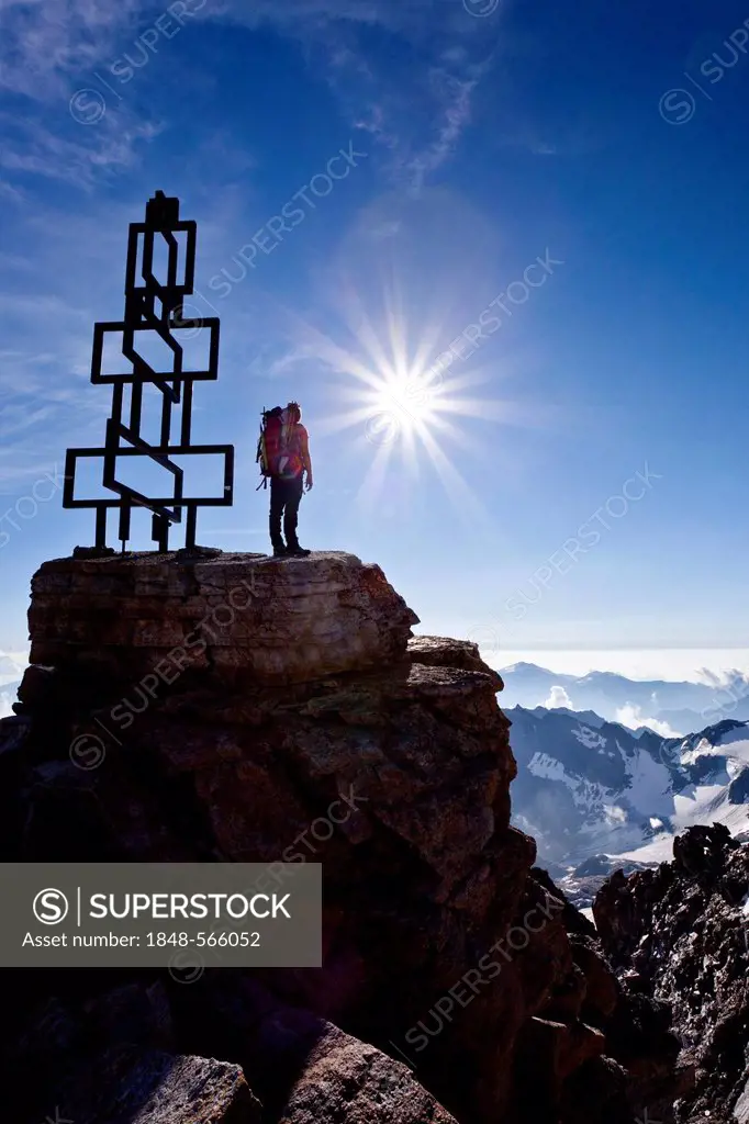 Mountaineer on the summit of Mt Hoher Angulus in the Ortler range, South Tyrol, Italy, Europe