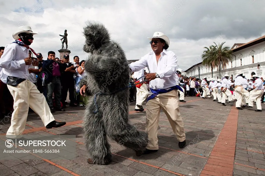 Male dance group on the edge of a procession during a car-free Sunday in the historic town centre of Quito, Ecuador, South America