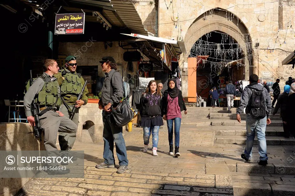 Israeli soldiers acting as security service at Damascus Gate, Palestinian youths passing, Arab quarter, old city, Jerusalem, Israel, Middle East