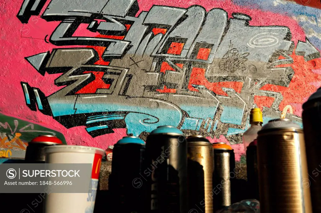Spray paint cans and graffiti on a concrete wall under the Ernst-Walz-Bridge, Heidelberg, Baden-Wuerttemberg, Germany, Europe