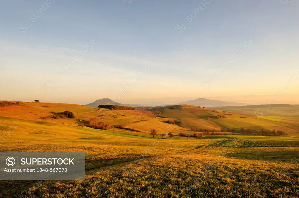 View from the old postal route near Leipferdingen across the landscape of the Hegau shortly before sunset, Mt Hohenhewen, left, and Mt Hohenstoffeln, ...