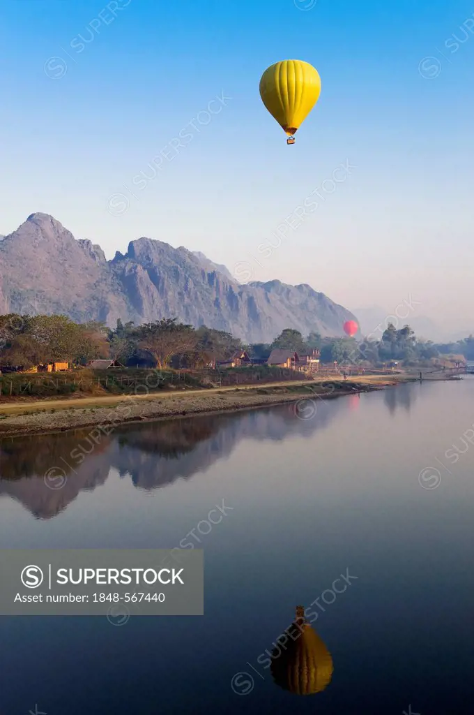 Hot air balloon flying over the karst mountains at the Nam Song River, Vang Vieng, Vientiane, Laos, Indochina, Asia