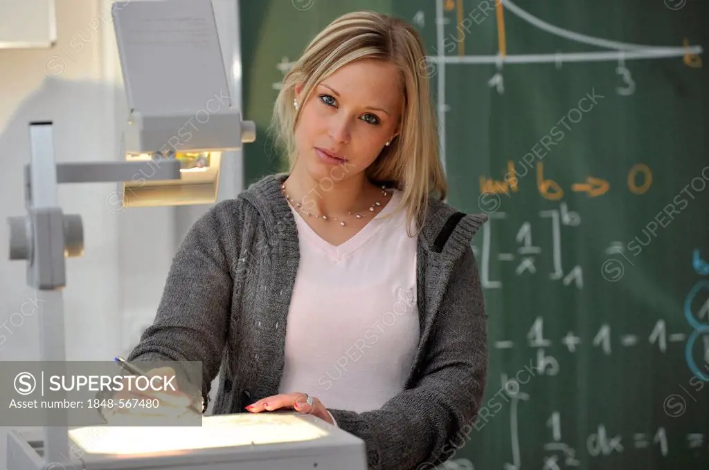 Trainee teacher, prospective teacher, young teacher, mathematics, blackboard, classroom, overhead projector, Baden-Wuerttemberg, Germany, Europe
