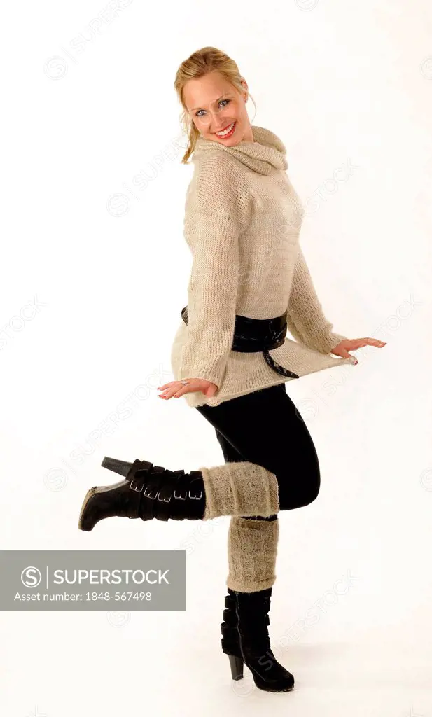 Young woman wearing a knitted sweater and boots