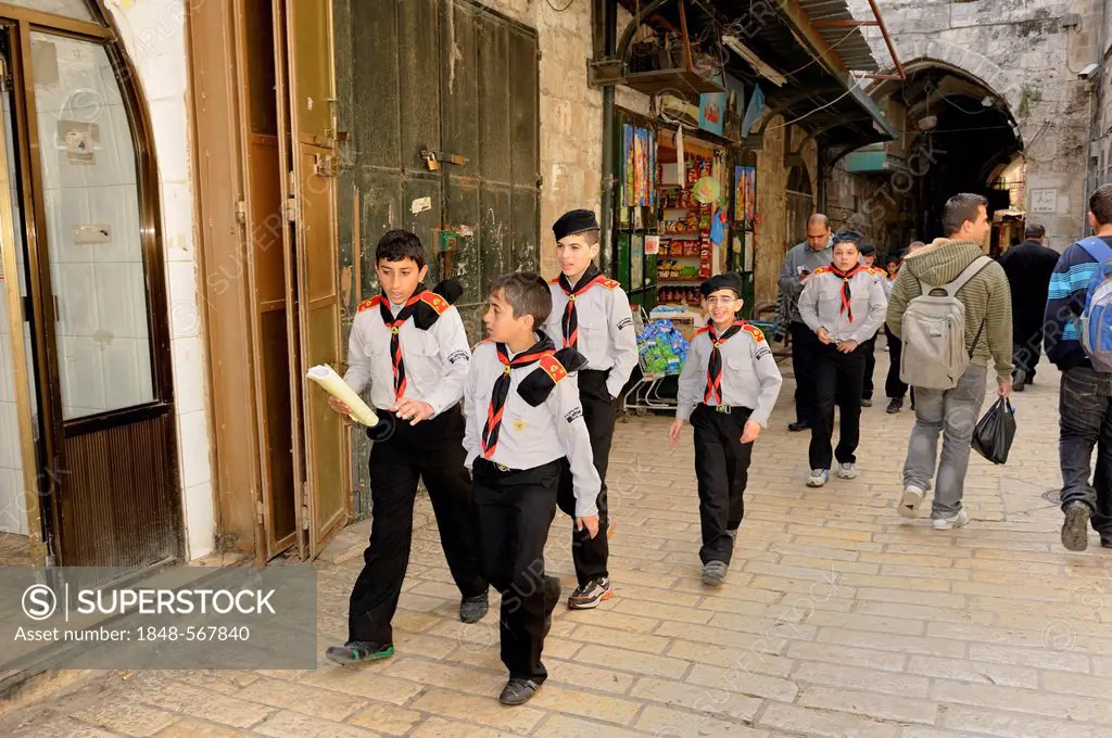 Boy scouts in uniform passing through the Arab quarter in the old city of Jerusalem, Israel, Middle East