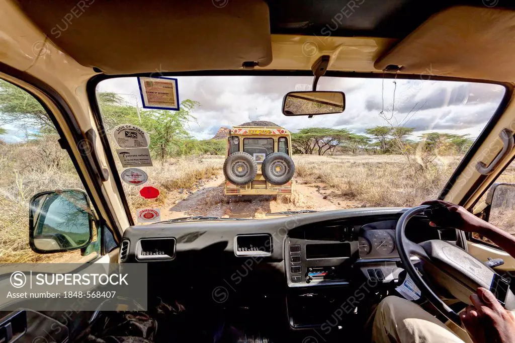 Safari bus following a Landrover over wet dirt tracks in the Samburu National Reserve, Kenya, East Africa, Africa, PublicGround