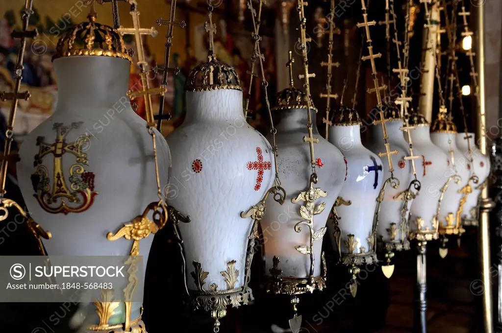 Oil lamps above The Stone of Anointing or The Stone of Unction, Church of the Holy Sepulchre or Church of the Resurrection, Jerusalem, Israel, Middle ...