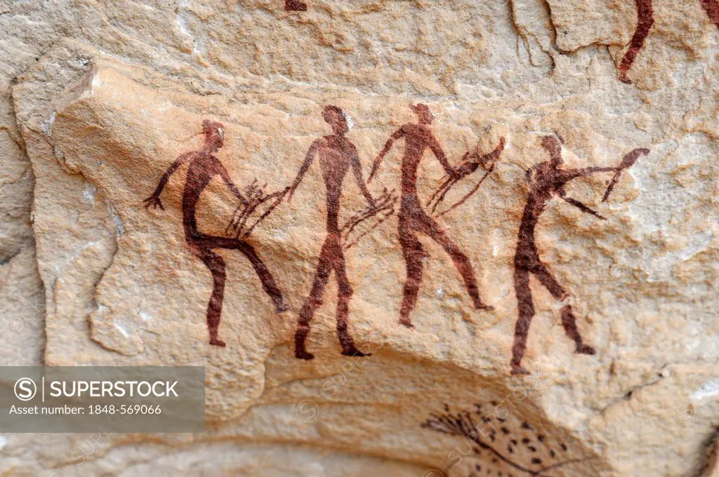 Group of painted warriors or hunters, neolithic rock art at Arakokem, Adrar Tekemberet, Immidir, Algeria, Sahara, North Africa