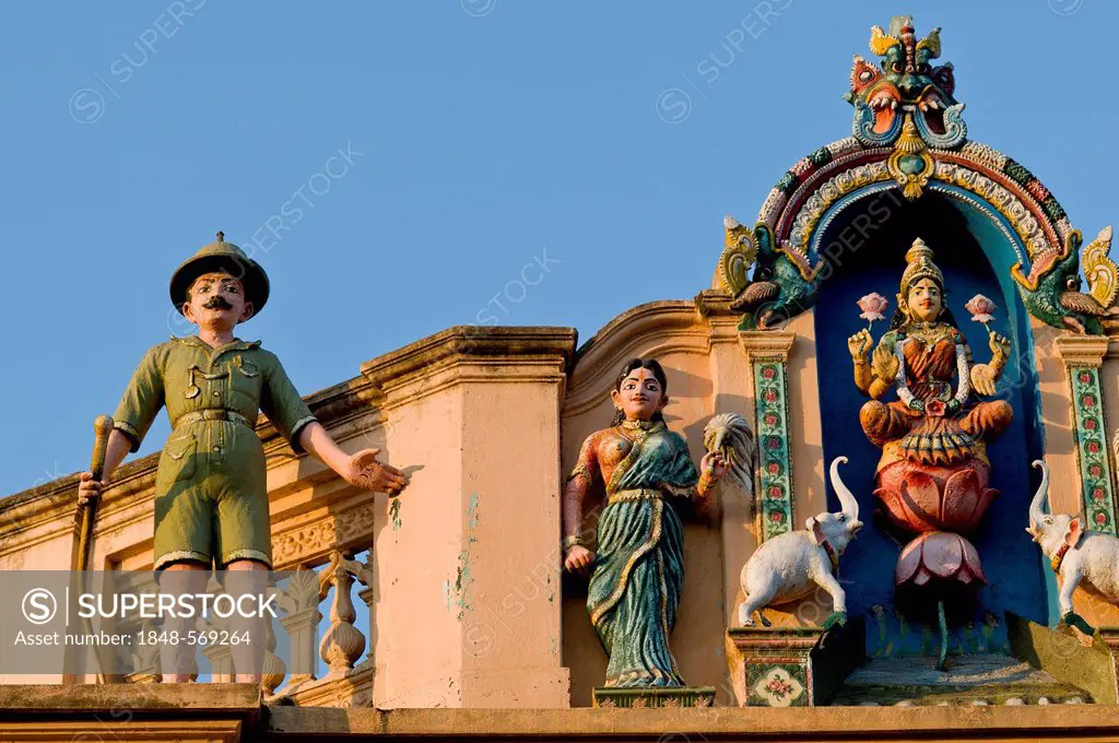 Indian Goddess Lakshmi flanked by elephants and British soldier in Uniform with a rifle, sculptural decoration on an old house, Karaikudi, Chettinad, ...