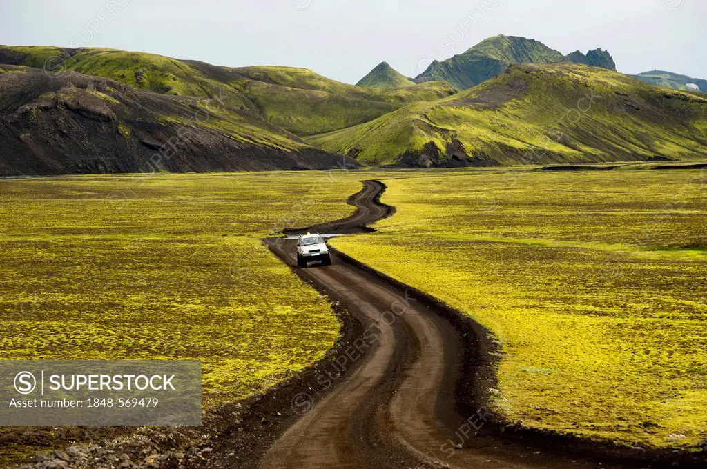 Super Jeep on the highland road, with moss-covered mountains, landscape surrounding Lake Langisjór, Highlands, Iceland, Europe