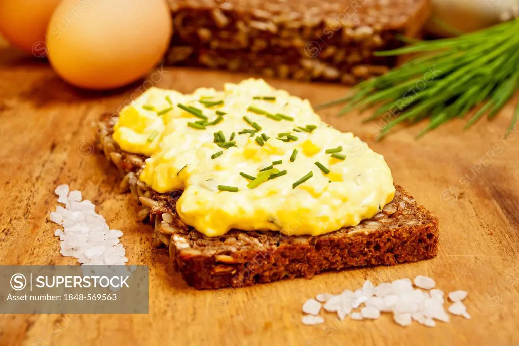 Dark brown rye bread with egg salad, egg and chives