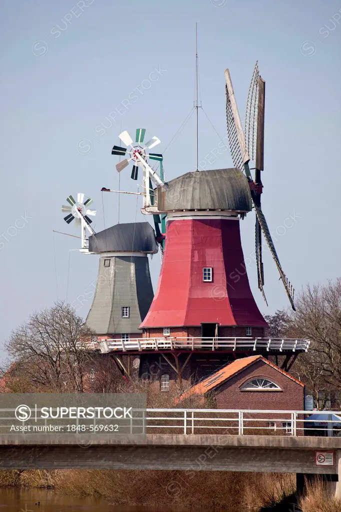 Greetsieler Zwillingsmuehlen windmills, two historic windmills in the resort town of Greetsiel, East Frisia, Lower Saxony, Germany, Europe