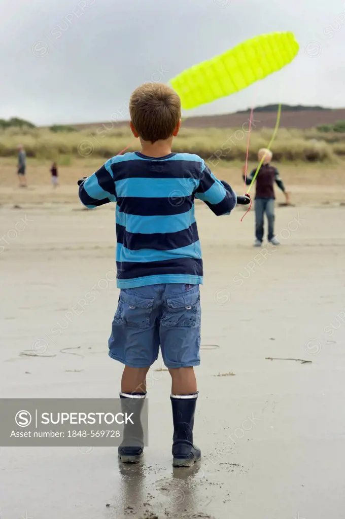 Boy flying a towing kite on the Atlantic beach, Finistere, Bretagne, Britanny, France, Europe, PublicGround