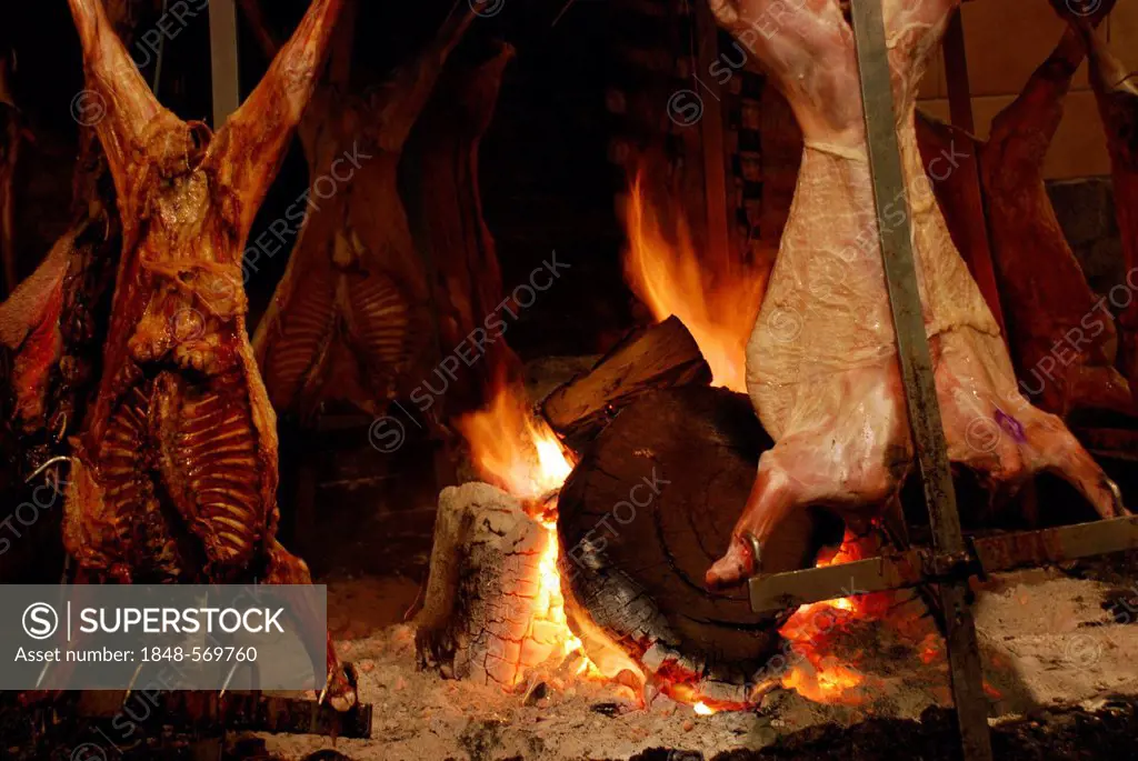 Meat roasting over an open fire, typical Argentinean preparation of steak, Buenos Aires, Argentina, South America