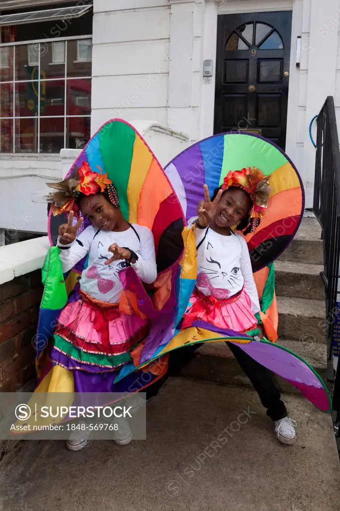 Two cheeky black girls at Notting Hill Carnival, costume parade, Notting Hill, London, England, United Kingdom, Europe