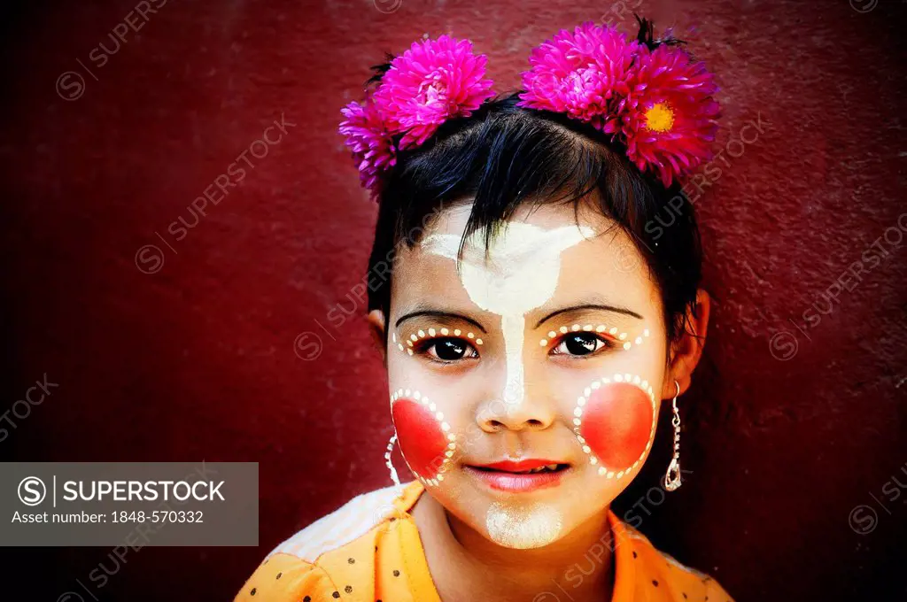 Girl with flowers in her hair, her face is painted with Thanaka cream, Bagan, Burma, Myanmar, Southeast Asia, Asia