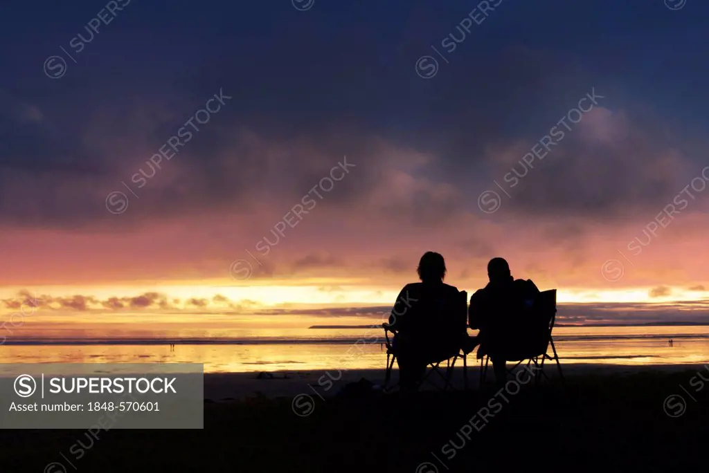 People on the beach watching the clouds at dusk, Atlantic Ocean, Finistère, Brittany, France, Europe