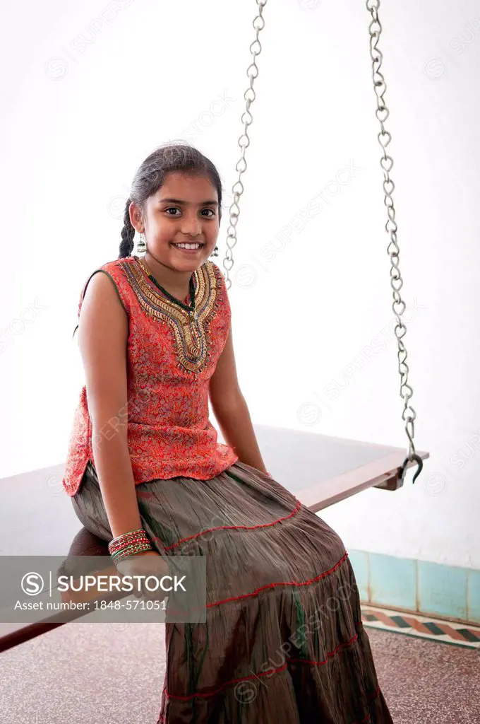 Indian girl sitting on a swing, Karaikudi, Chettinad, Tamil Nadu, South India, India, Asia