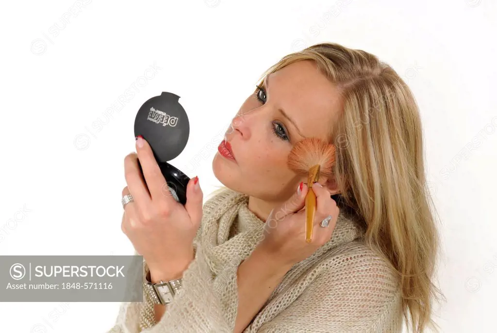 Young woman applying make-up, powder, brush