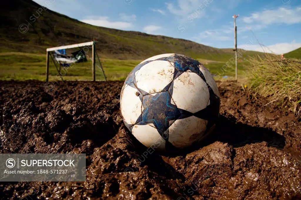 A soccer ball and a goal, European championships of mud-soccer, town of Isafjordur, West Fjords, Iceland, Europe
