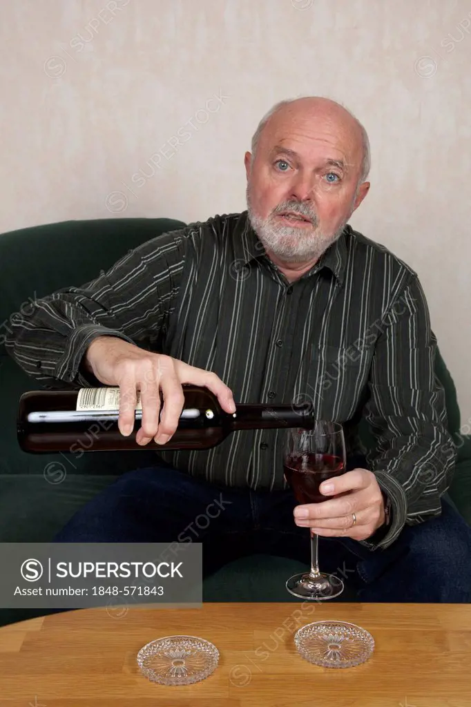 Senior man pouring wine