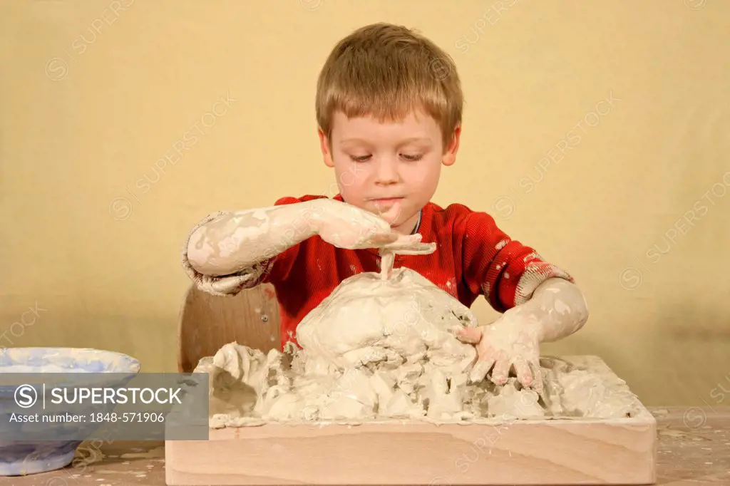 Boy doing art therapy with clay