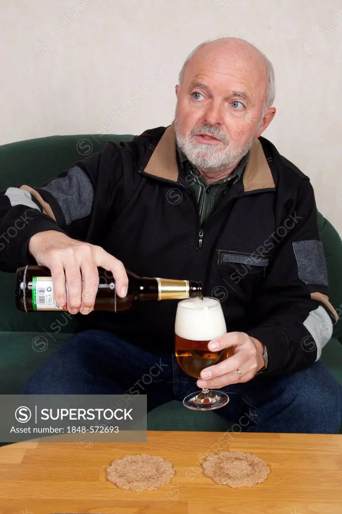Senior man pouring a beer