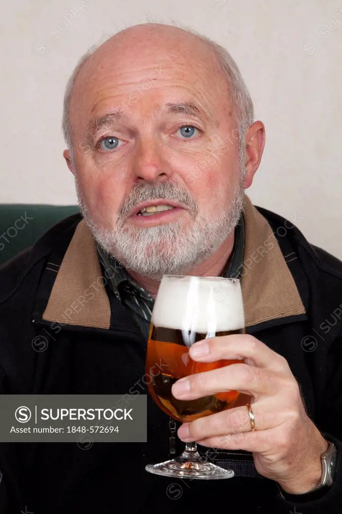 Senior man holding a beer glass