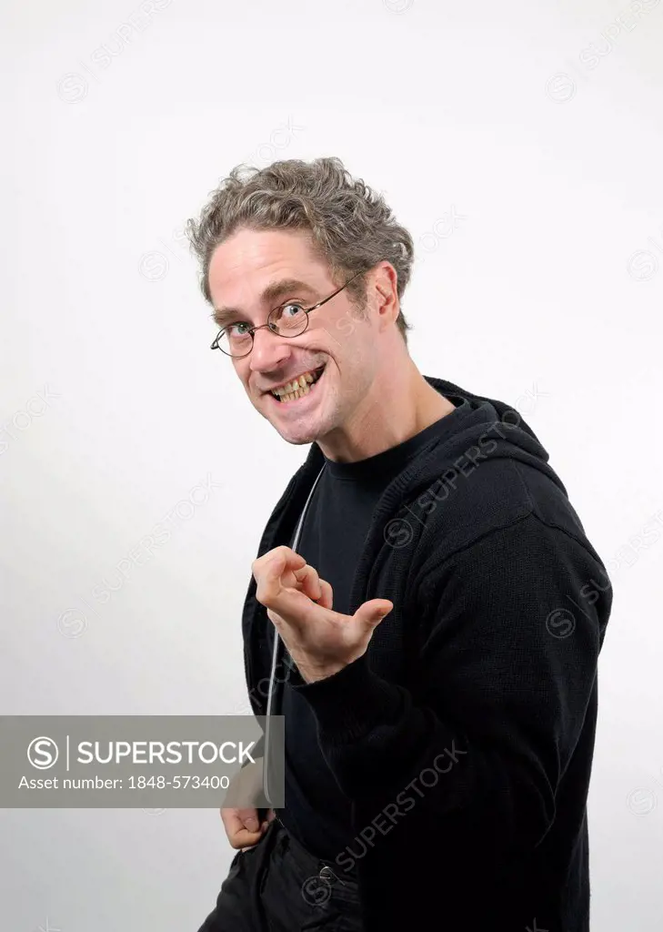 Young man with glasses playing air guitar