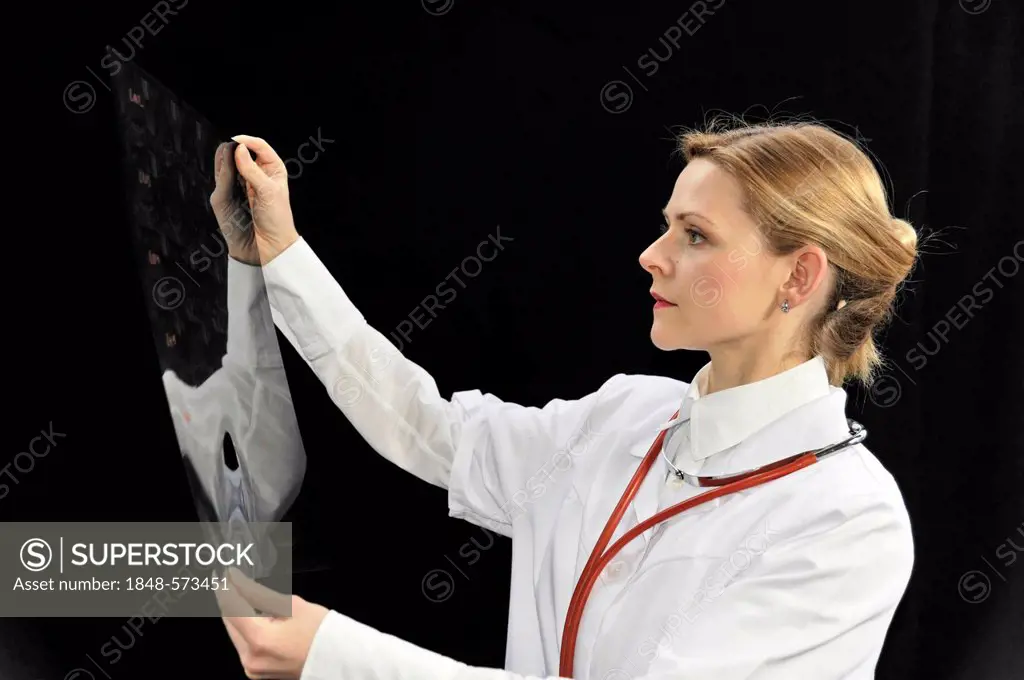 Assistant physician, young doctor looking at an X-ray
