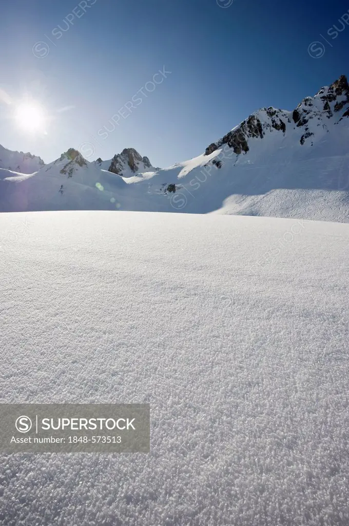 Deep snow with mountain peaks and the sun, Tignes, Val d'Isere, Savoie, Alps, France, Europe