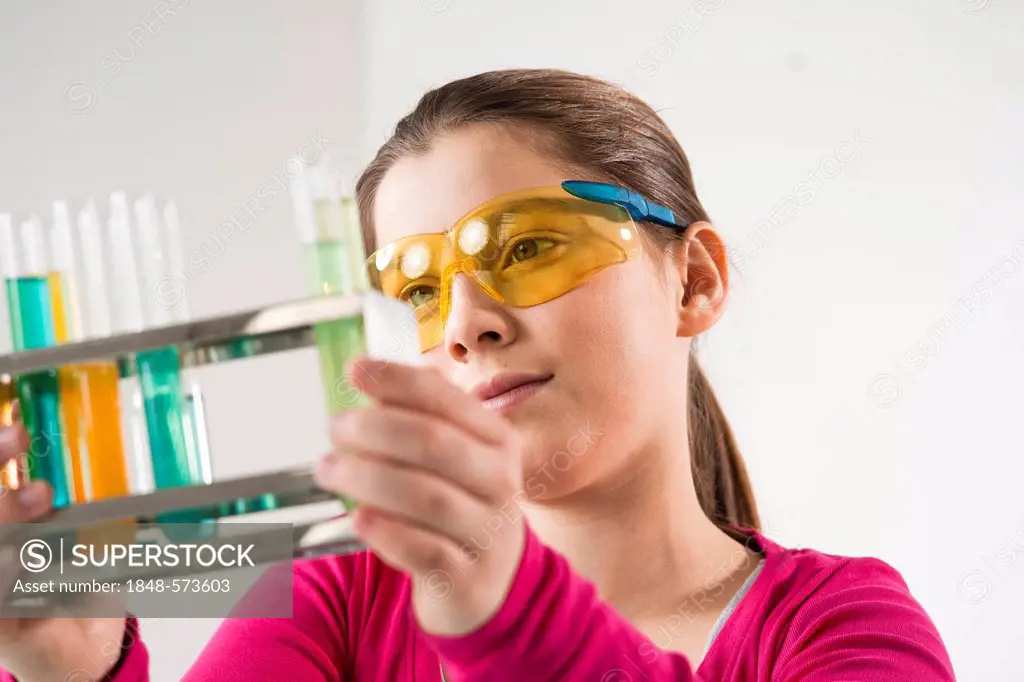 Girl holding test tubes