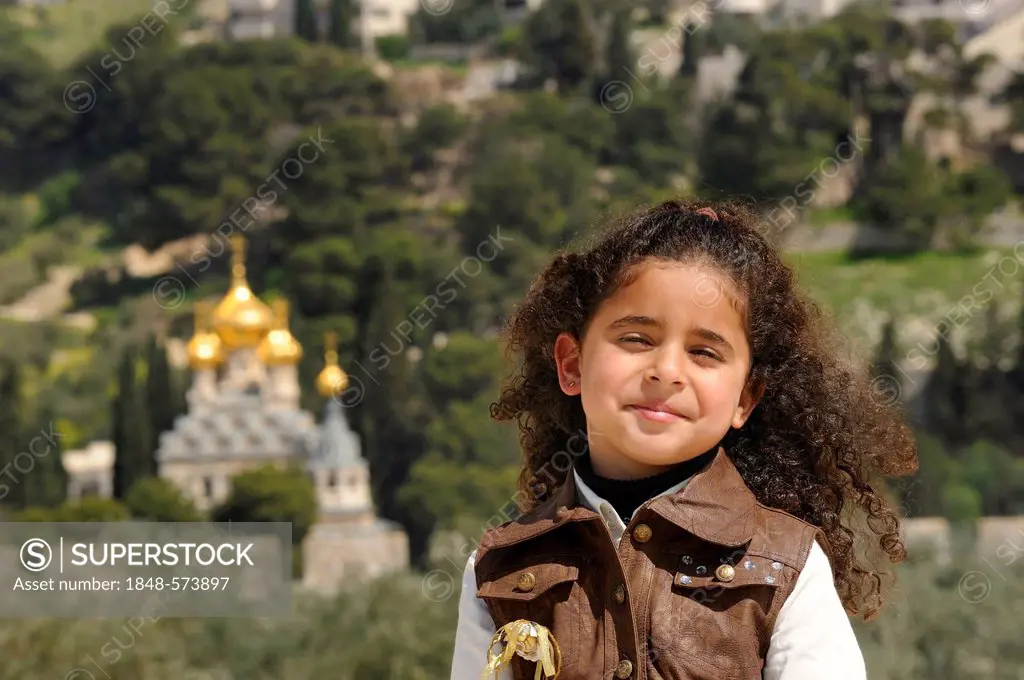 Religious diversity, Israeli-Palestinian girl on the Temple Mount, Russian Orthodox Church of Mary Magdalene on the Mount of Olives at back, Muslim Qu...