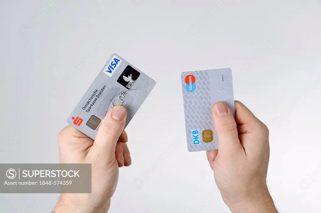 Hands holding bank cards, debit cards